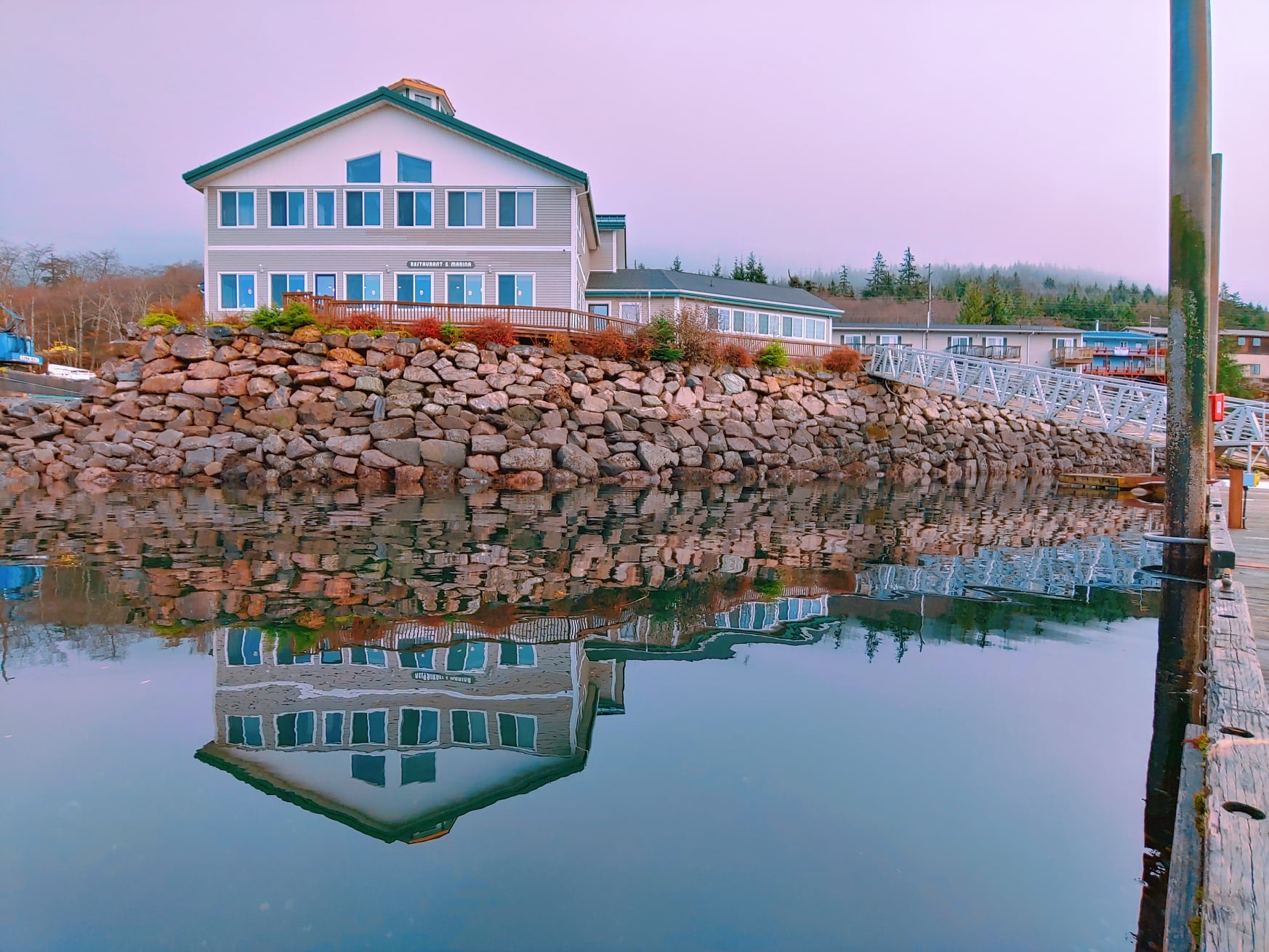 The Ketch Inn building reflected in calm water